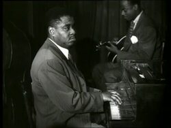 B/W close up of black man playing piano / guitarist in background / Art Tatum Stock Footage