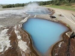 MS Shot of geothermal steaming water holes beside boardwalk at geysir Park / Haukadalur, Haukadalur, Iceland Stock Footage