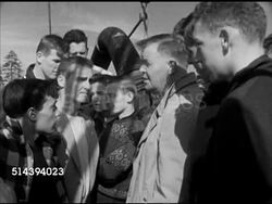 1952: PORTLAND HIGH SCHOOL WORKSHOP: VS Wake of water from moving boat, Portland H.S. students & Dr. James Flanagan observing sardine fishermen in rowboat, fishing for sardines w/ net, Flanagan explaining process of netting (SOT). Maine, ME Instructional Video
