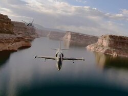 AIR TO AIR, Two Aero L-39 Albatroses flying over Grand Canyon and lake, Arizona, USA Stock Footage