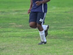 A man playing soccer on a grassy field. - Slow Motion - filmed at 240 fps Stock Footage