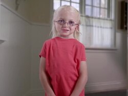 Litttle blond girl with Cochlear Implant standing in a hall way Stock Footage