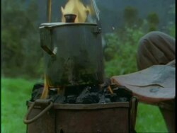 MS black kettle hanging above camp fire, Uganda, Africa Stock Footage