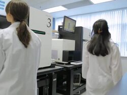 MS POV Lab technicians working on HiSeq2000s DNA sequencers / Vancouver, BC, Canada Stock Footage