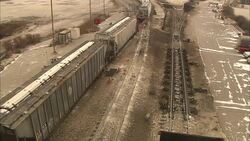 Box cars and coal cars slowly travel along railroad tracks. Stock Footage
