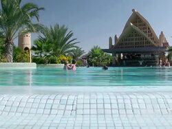 MS View of People swimming in pool at RIU Hotel Furana / Santa Maria, Sal, Cape Verde Stock Footage