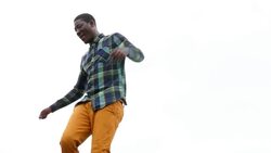 MS LA Man dancing along rooftop wall Stock Footage