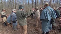 US Civil War re-enacters stood around fire News Clip