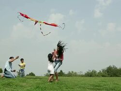 Family flying kite in the park, Delhi, India Stock Footage