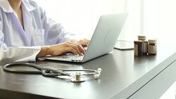 Young Woman doctor browsing pages on laptop, typing letter, consulting patients Stock Footage