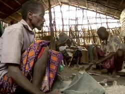 Man pushing air into fire with bellows Stock Footage