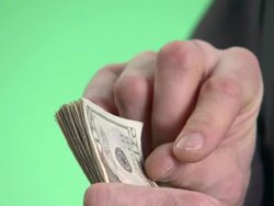 ECU, Businessman flicking through banknotes in studio, close-up of hands Stock Footage