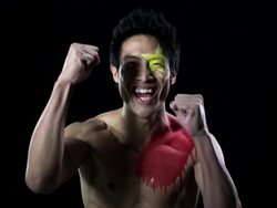 Man with Chinese flag painted on face and chest clapping Stock Footage