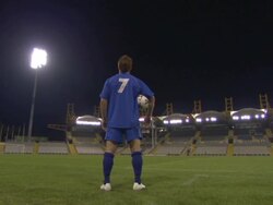 LA WS Soccer player standing in empty stadium at night / Sheffield, England, UK Stock Footage