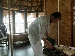 Couple in beach hut getting undressed and embracing Stock Footage