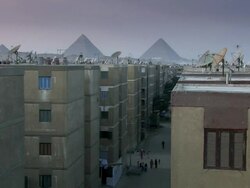 MS Shot of rooftop inside city with pyramids / Caire, Egypt Stock Footage