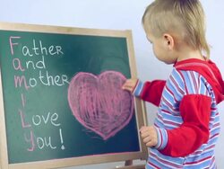 boy draws compliments for parents Stock Footage