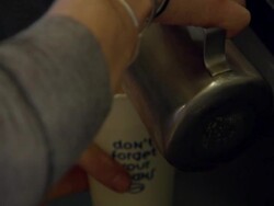 Milk being poured into coffee by barista News Clip