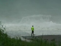 Man photographing massive waves on beach; Typhoon Jangmi, Taiwan 28th September 2008 (With Audio) Stock Footage