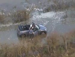 Aerials of Couple Stuck in Car in Flooded Lane News Clip