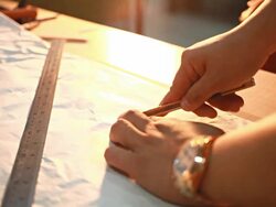 HD Dolly:Using a paper cutter on the table. Stock Footage