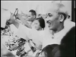 B/W 1950s PROFILE Ho Chi Minh smiling + waving outdoors / North Vietnam / newsreel Stock Footage