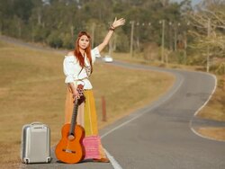Hippie girl hitchhiking Stock Footage