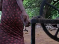 Unidentified Indian women make rope out of coconut fibers at an outdoor factory Stock Footage