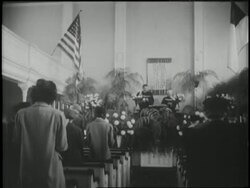 A congregation attends a funeral service. News Clip