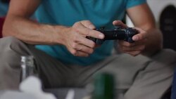Guys sitting on couch playing video games Stock Footage