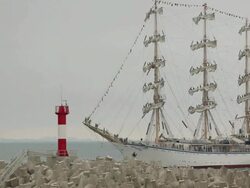 beautiful old sailing ship and lighthouse Stock Footage