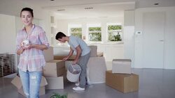 Portrait of smiling woman drinking coffee near moving boxes Stock Footage