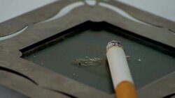Lit cigarette in ashtray rotating Stock Footage