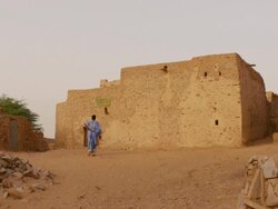 A man walking to the library of Chinguetti Stock Footage