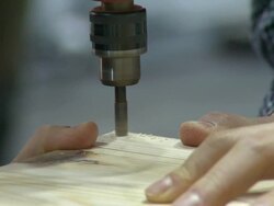 Shot of drilling plywood and driving a screw with drill Stock Footage