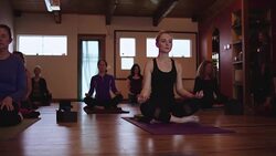 Young attractive blonde attending a yoga class Stock Footage