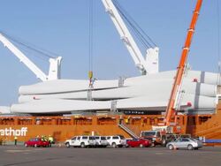 MS T/L Shot of Cranes lifting giant wind turbine blades off container ship / Macarthur, Victoria, Australia Stock Footage