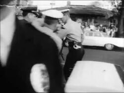 B/W 1963 policemen using force to arrest angry Black woman at civil rights protest / Alabama / news. Stock Footage