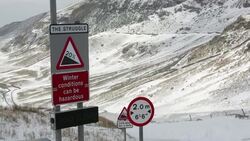 Massive snow drifts block the Kirkstone Pass road above Ambleside in the Lake District, UK during the extreme weather event of late March 2013. shot taken on 25th March 2013. Stock Footage