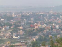 WS ZO View of cityscape with young monks sitting on bench / Kathmandu, Central, Nepal Stock Footage