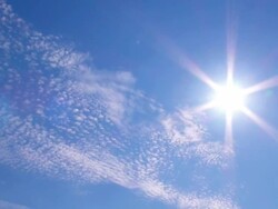 Cirrocumulus clouds and sun in blue sky Stock Footage