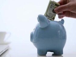 Twenty dollar bill being placed in to Piggy bank. Stock Footage