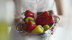Hand washing peppers, slow motion under a tap   FO Stock Footage
