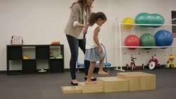 Female physical therapist working with child patient in clinic Stock Footage