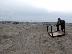 WS Young businessman in black suit turning over  table on top of  bluff in  rural area / Maple Grove, Minnesota, United States Stock Footage