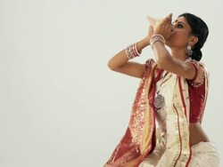 Bengali girl blowing a conch shell  Stock Footage