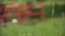 An empty merry-go-round rotates on a children's playground. Stock Footage