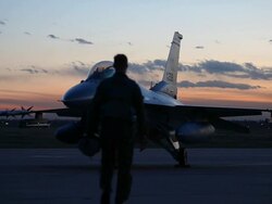 WS F-16 pilot approaching F-16 fighter jet at sunset, Aurora, Colorado, USA Stock Footage