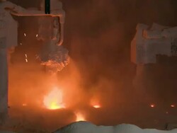 Medium static - Flames flare up as raw materials are poured into a furnace /  Kansas, United States Stock Footage