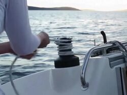CU woman winding rope around winch on yacht. Stock Footage